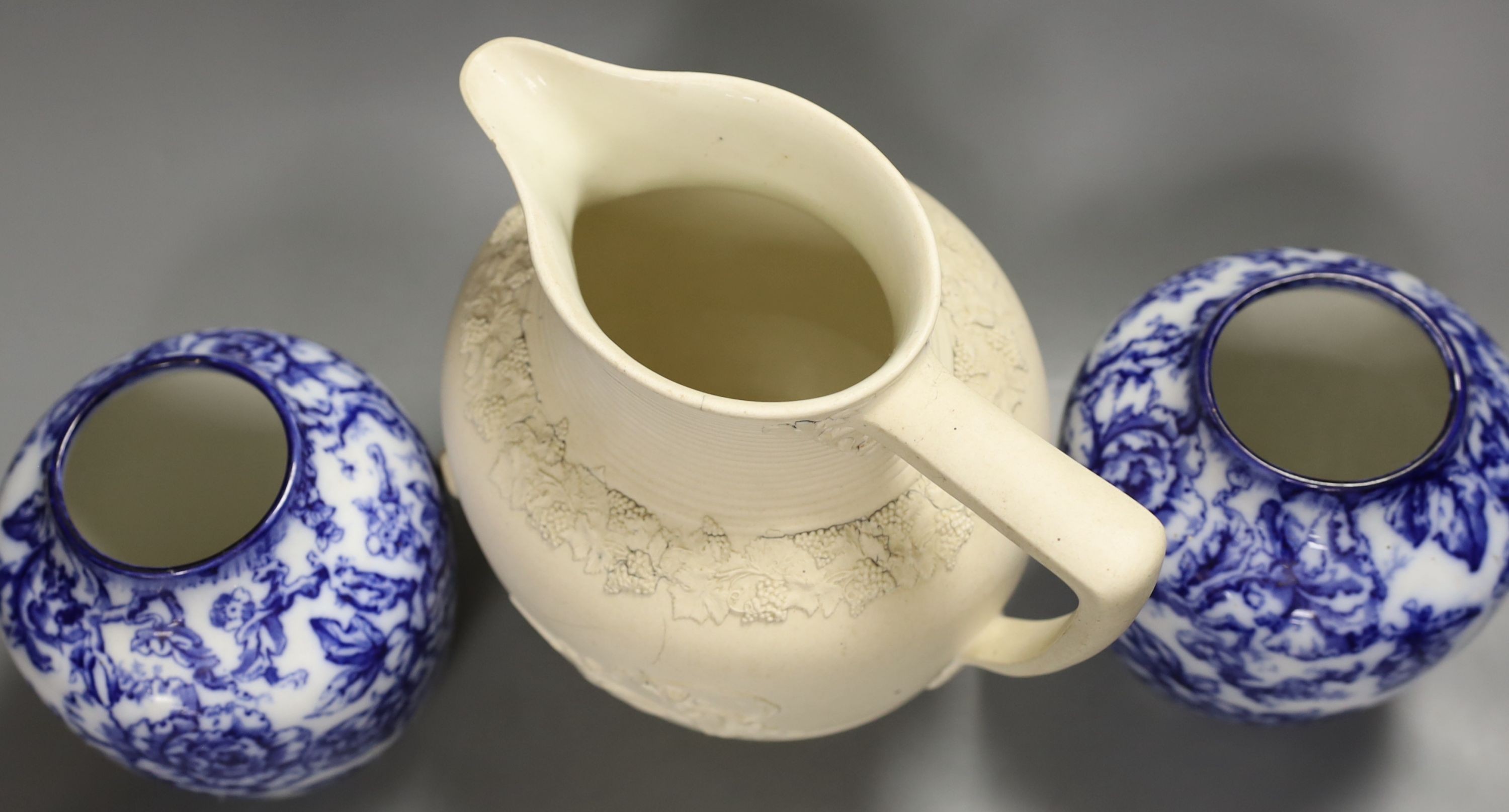 A pair of Keelings blue and white floral vases and a 19th century relief moulded white stoneware jug, vases 17 cms high.